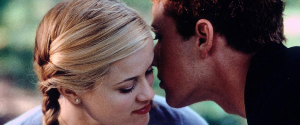 PHOTO: Reese Witherspoon listens as Ryan Phillippe whispers in her ear in a scene from the film "Cruel Intentions," 1999. 