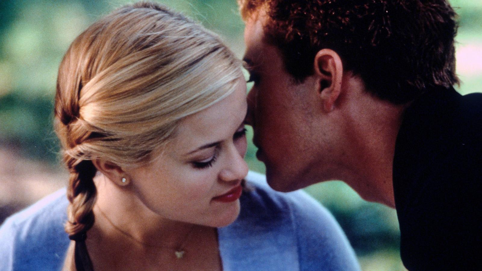 PHOTO: Reese Witherspoon listens as Ryan Phillippe whispers in her ear in a scene from the film "Cruel Intentions," 1999.