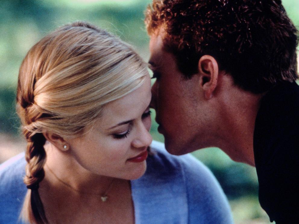 PHOTO: Reese Witherspoon listens as Ryan Phillippe whispers in her ear in a scene from the film Cruel Intentions, 1999. 