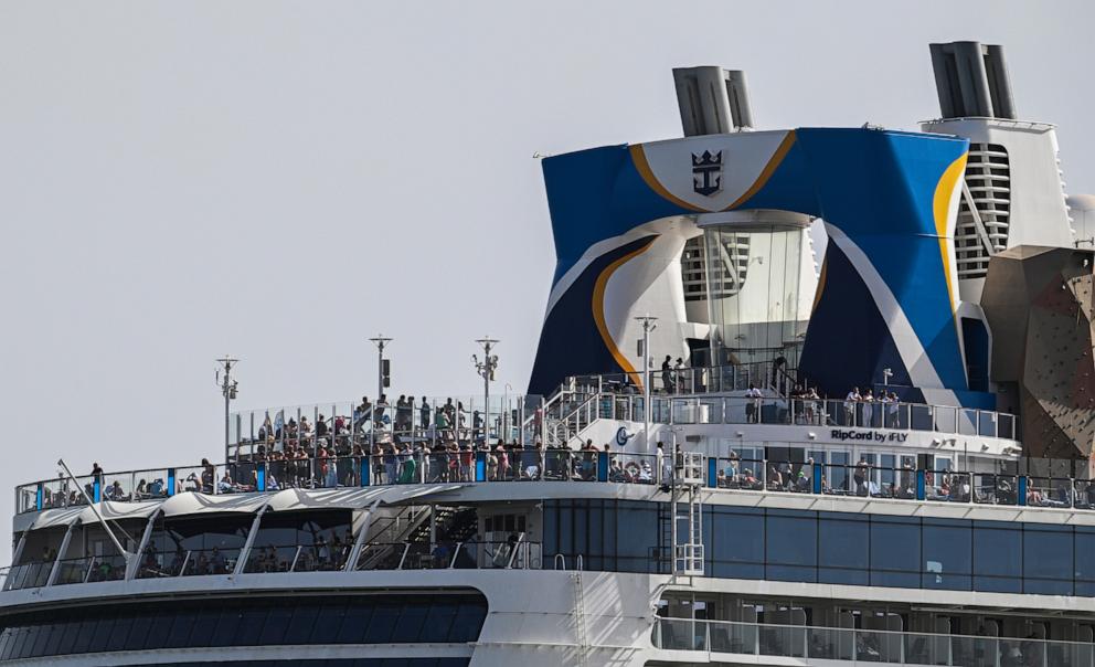 PHOTO: Tourists crowd upper decks as the Anthem of the Seas cruise ship sails the Tagus River after leaving the city's cruise terminal, Aug. 9, 2023, in Lisbon, Portugal. 