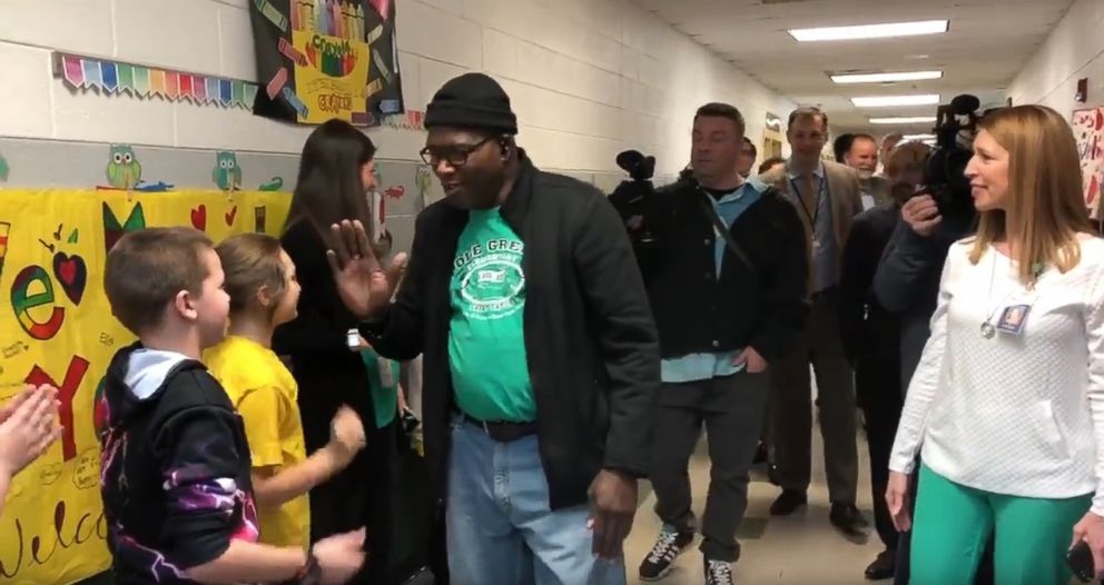 PHOTO: Tyrees Dandridge, known to students as Mr. D., high fives students at Pole Green Elementary School in Virginia, on Feb. 25, after he received a heart and kidney transplant. 