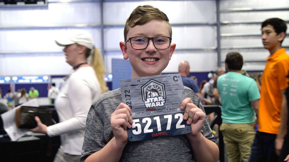 PHOTO: D.J. Roberts holds up his bib for the 2019 runDisney Star Wars Rival Run 5K.