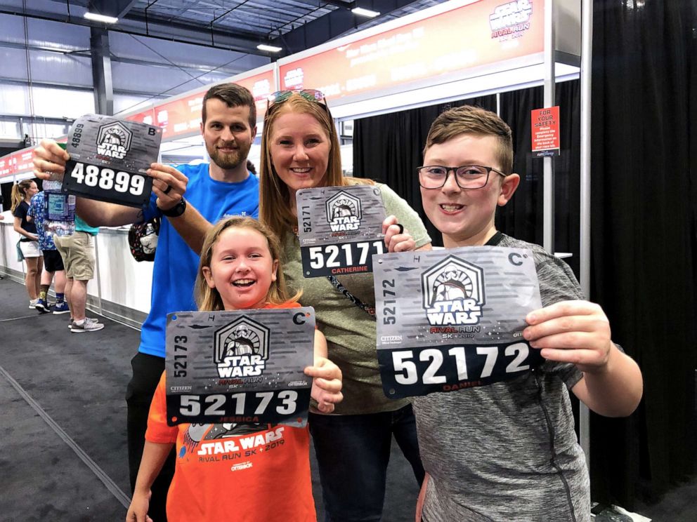 PHOTO: D.J. shows off his race bib along with his trainer, mother and younger sister, who are running with him. 