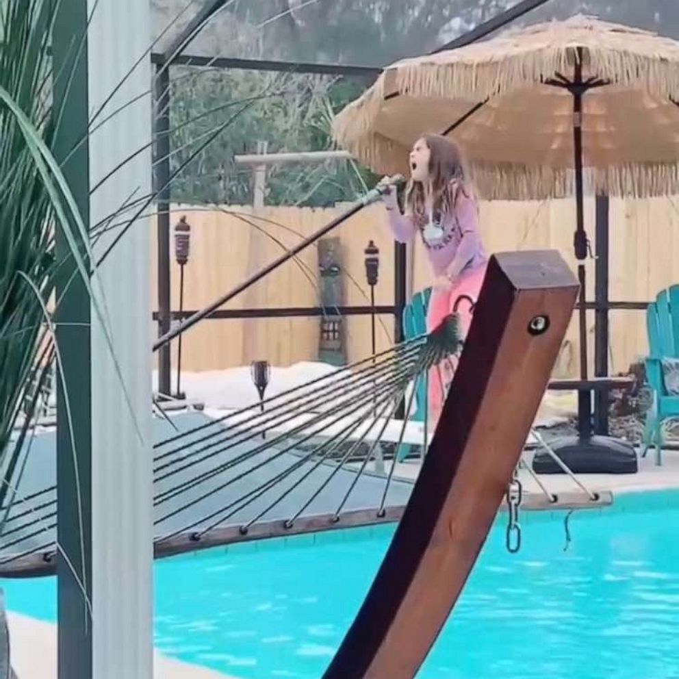 VIDEO: Dad secretly films 8-year-old as she belts ‘Girl on Fire’ while cleaning the pool