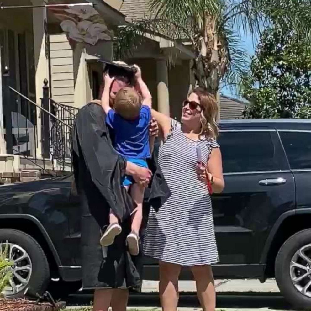 VIDEO: 3-year-old gives dad his 'diploma' in front yard graduation celebration 
