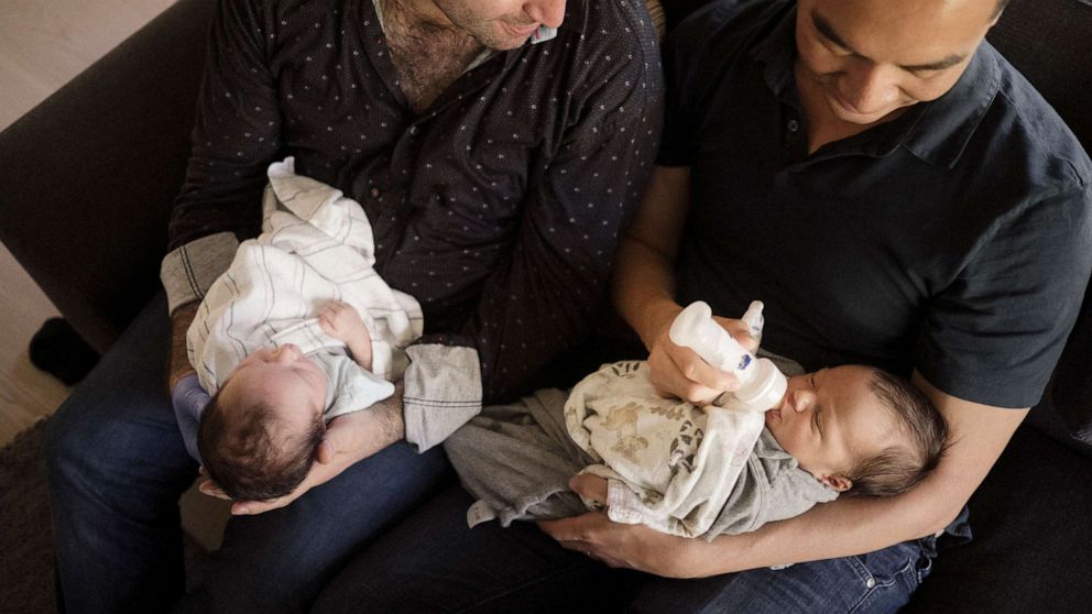 PHOTO: George Arison, right, and his husband Robert Luo welcomed their children, Luka and Emilia, in September 2019.

