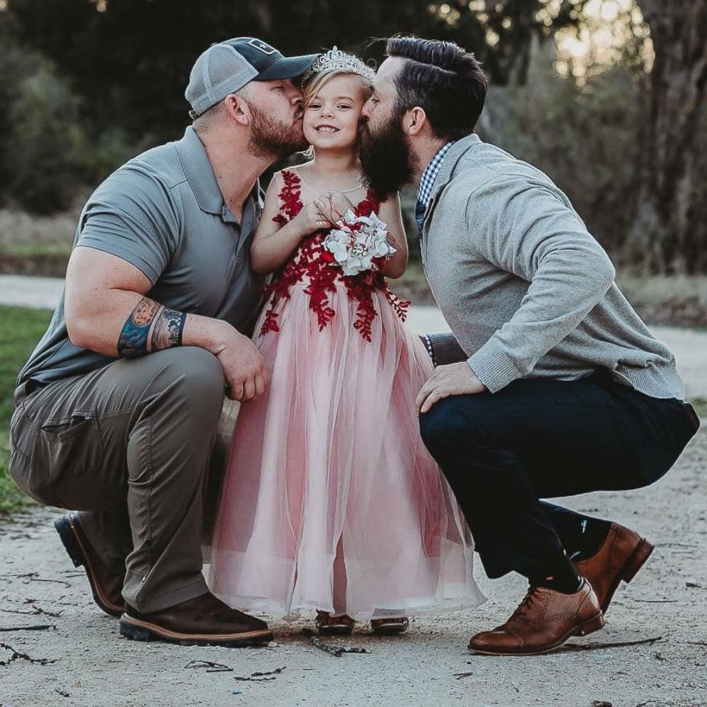 'We are the adults' Dad and stepdad pose with daughter before father