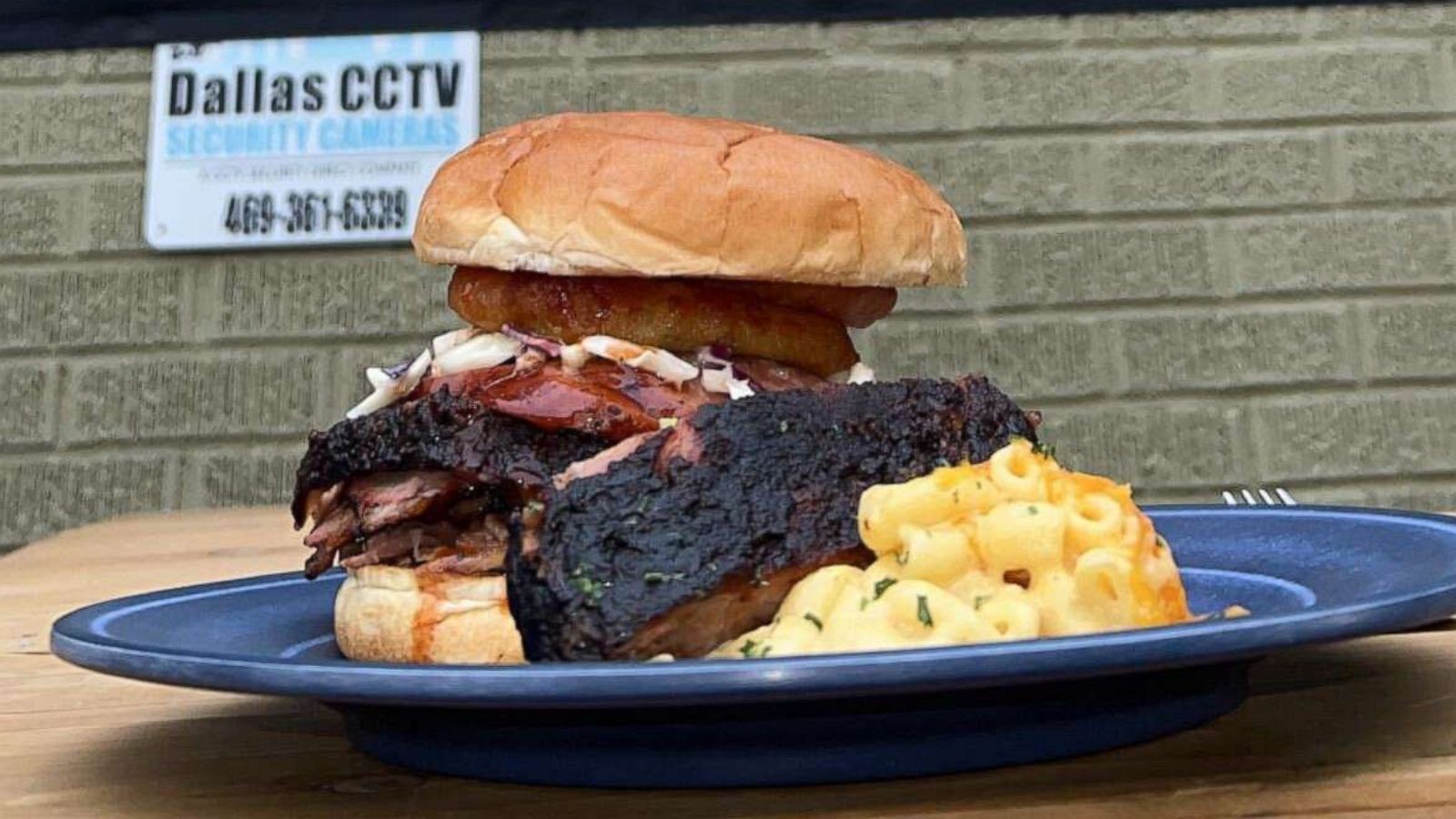 PHOTO: The big John sandwich, hickory-smoked brisket, sausage and coleslaw topped with an onion ring, from Smokey John's Bar-B-Que & Home Cooking.