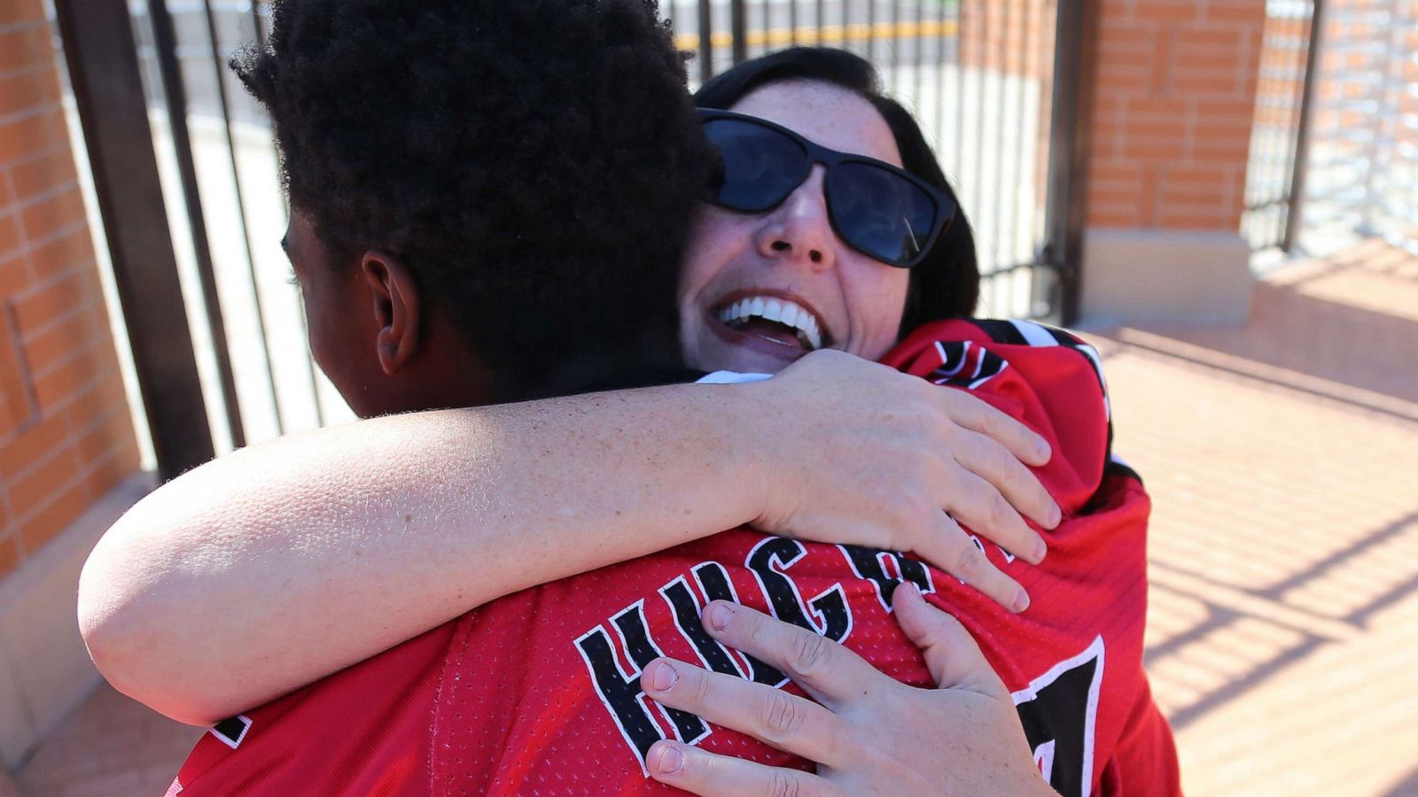 PHOTO: Dana Gendreau hugs the Hughes football player as they get off the bus before there game on Oct. 6, 2019.