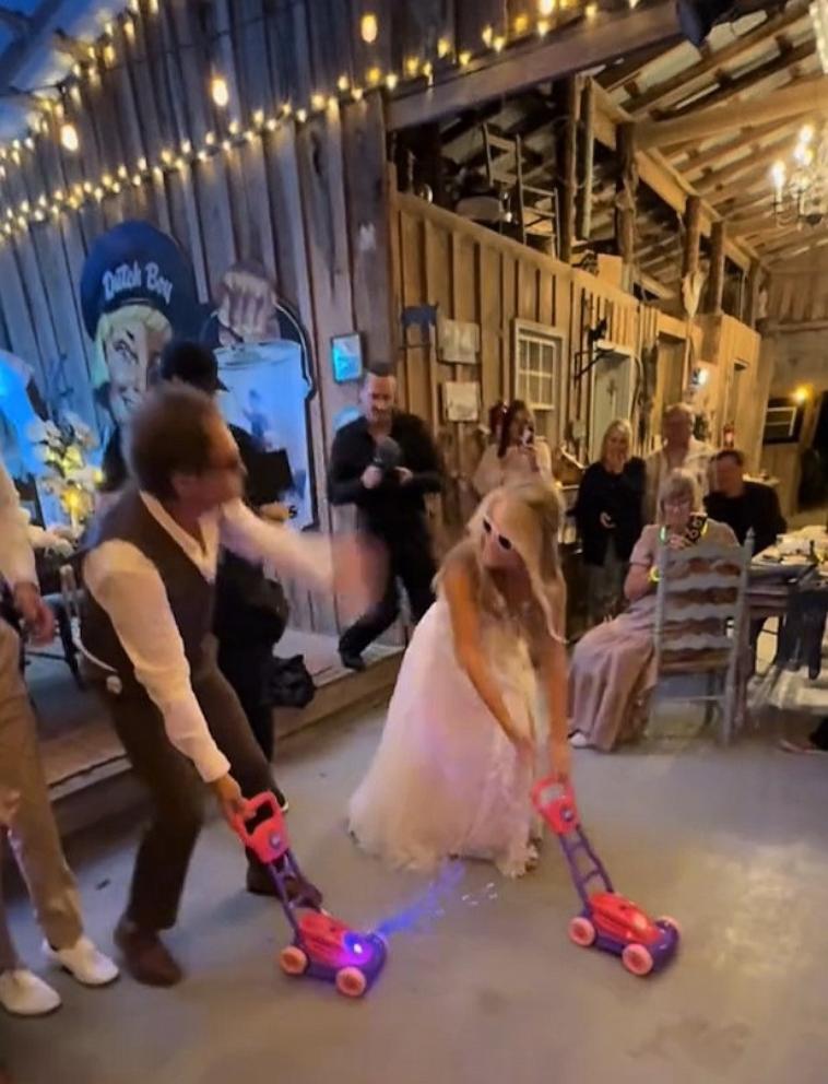 PHOTO: Sidnie Rollins shared a TikTok video of her wedding dance medley, including props, with her father-in-law Mark.