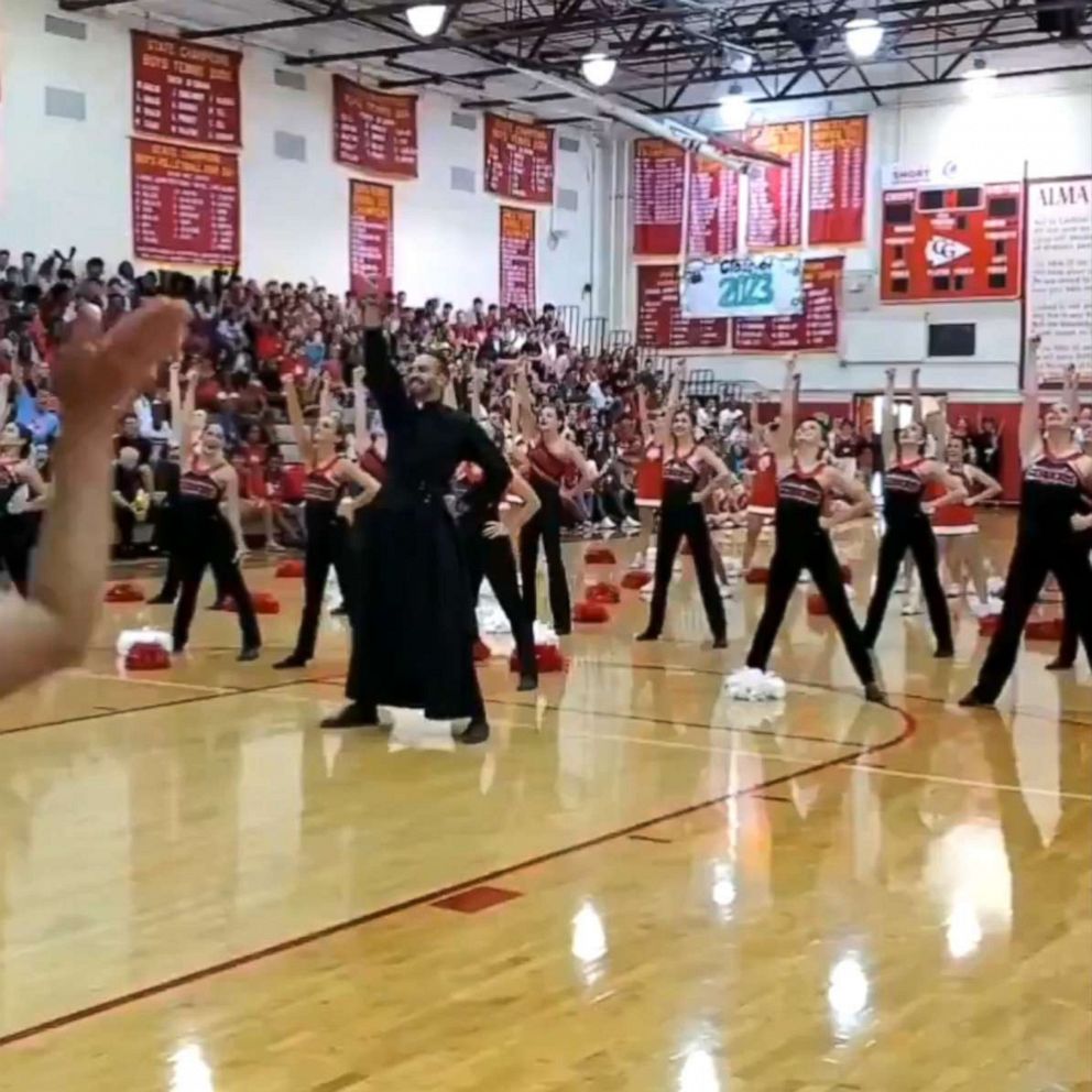 VIDEO: This dancing priest busts a move at a school pep rally in viral video