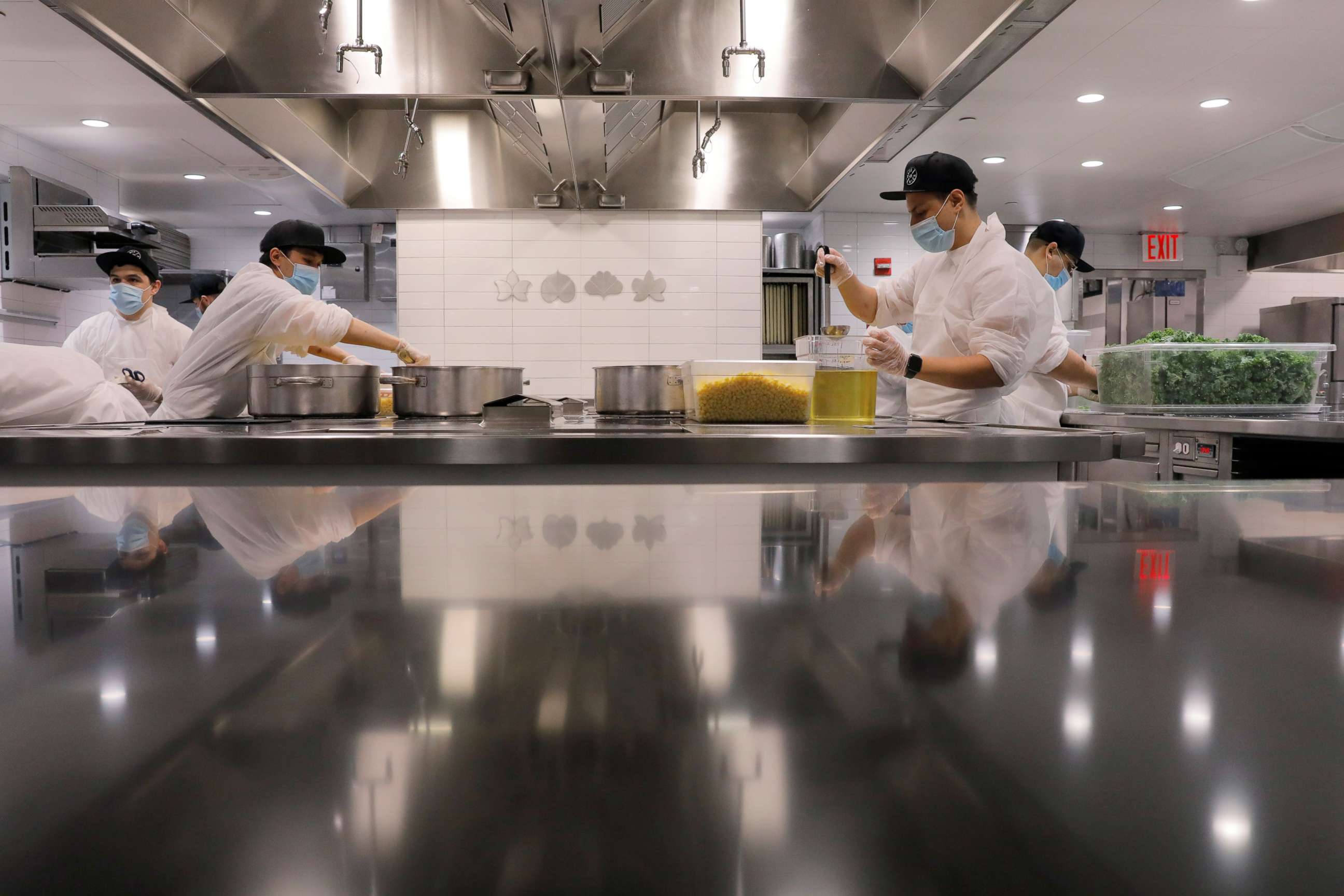 PHOTO: Kitchen staff work to create food donation boxes to give to needy families in the kitchen of Michelin starred restaurant Eleven Madison Park in New York, May 20, 2020.