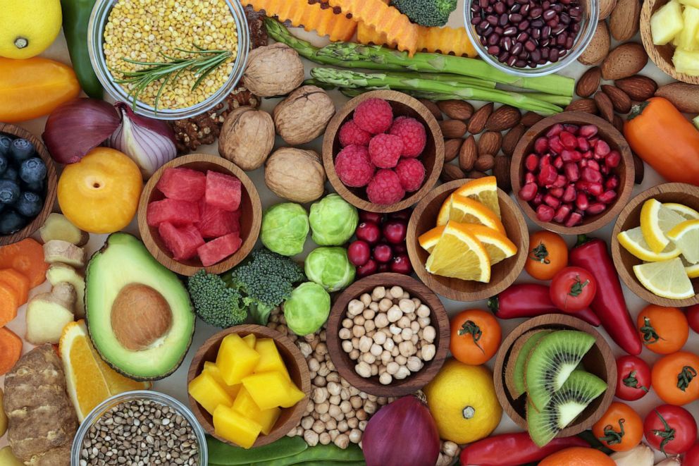 PHOTO: Healthy food selection with fresh vegetables, fruit, herbs, pulses, seeds and nuts.