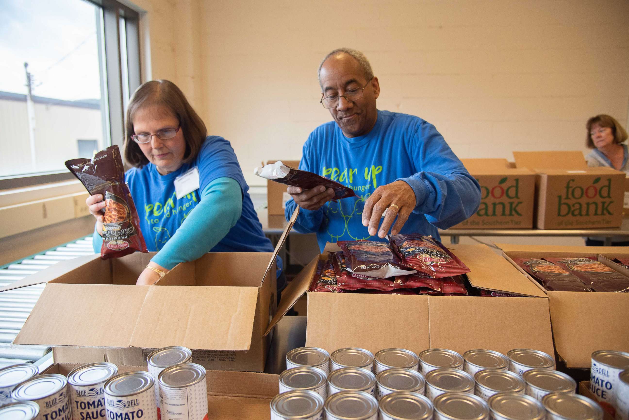 PHOTO: Volunteers at Food Bank of the Southern Tier in Upstate New York pack emergency food boxes and bag produce for drop and go delivery at Mobile Food Pantry sites and for distribution through regional school districts.