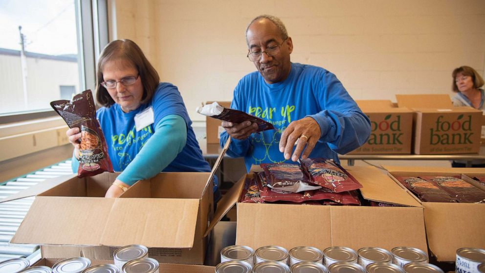 PHOTO: Volunteers at Food Bank of the Southern Tier in Upstate New York pack emergency food boxes and bag produce for drop and go delivery at Mobile Food Pantry sites and for distribution through regional school districts.