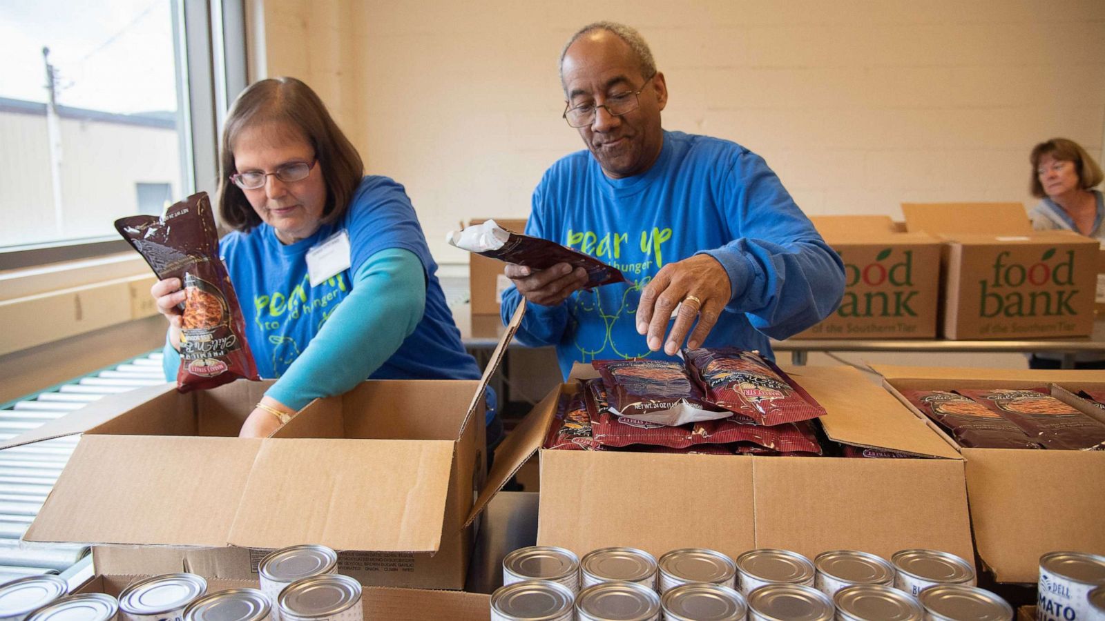 PHOTO: Volunteers at Food Bank of the Southern Tier in Upstate New York pack emergency food boxes and bag produce for drop and go delivery at Mobile Food Pantry sites and for distribution through regional school districts.