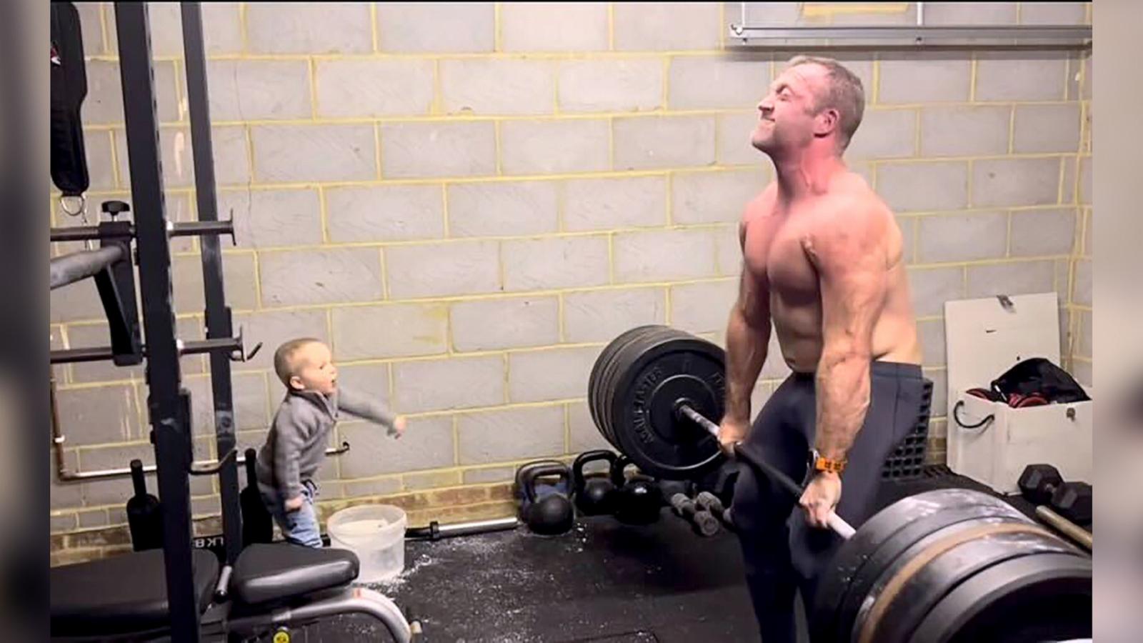 PHOTO: Thomas Perry enthusiastically cheers on his father, James Perry, as he deadlifts.