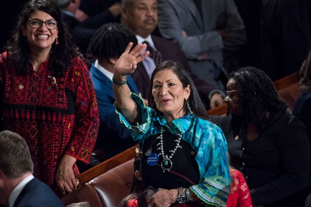 PHOTO: Reps. Deb Haaland, right, and Rashida Tlaib, left, are seen in the Capitol's House chamber before members were sworn in on the first day of the 116th Congress in Washington, Jan. 3, 2019.