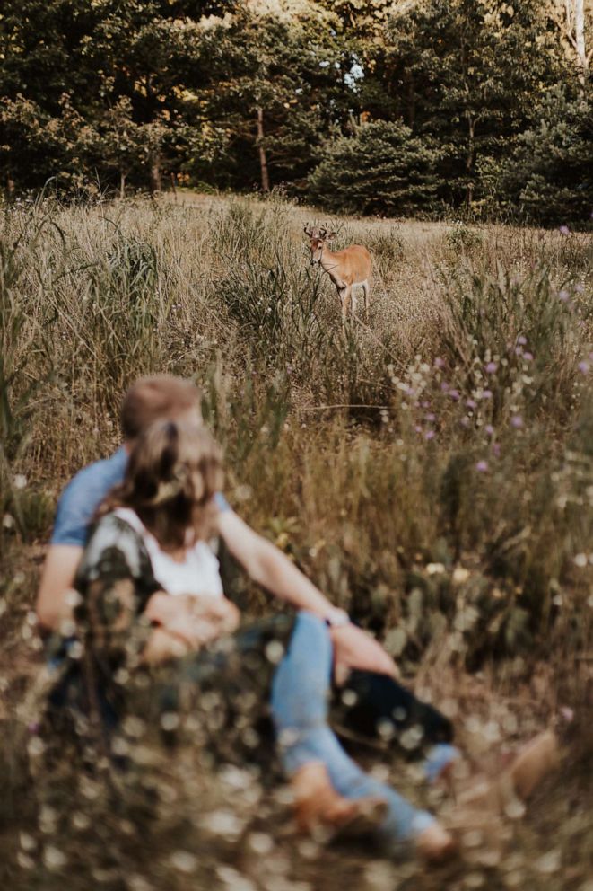 PHOTO: The couple noticed the deer wandering into their photo shoot.