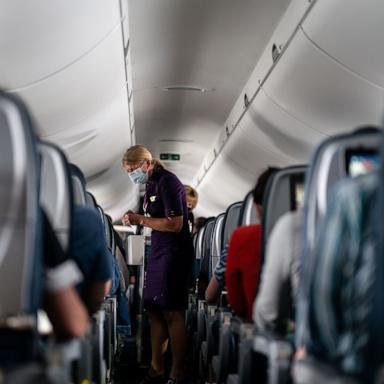PHOTO: Flight attendants hand out refreshments to a packed Delta Airlines flight traveling from Ronald Regan National Airport to MinneapolisSaint Paul International Airport, May 21, 2021.