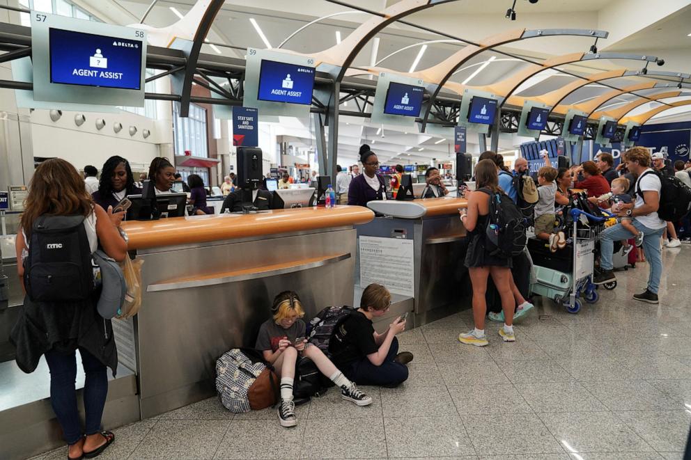 PHOTO: People speak to Delta agents as they try to rebook their travel plans after long delays following cyber outages affecting airlines at Hartsfield-Jackson Atlanta International Airport in Atlanta, Georgia, July 22, 2024. 