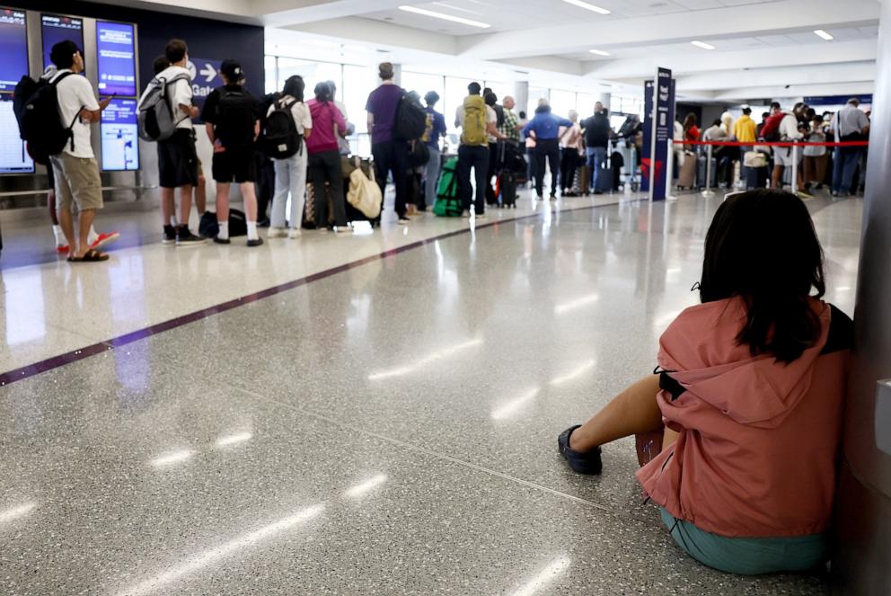 PHOTO: Travelers wait on the check-in floor of the Delta Air Lines terminal at Los Angeles International Airport (LAX) on July 23, 2024 in Los Angeles, California.