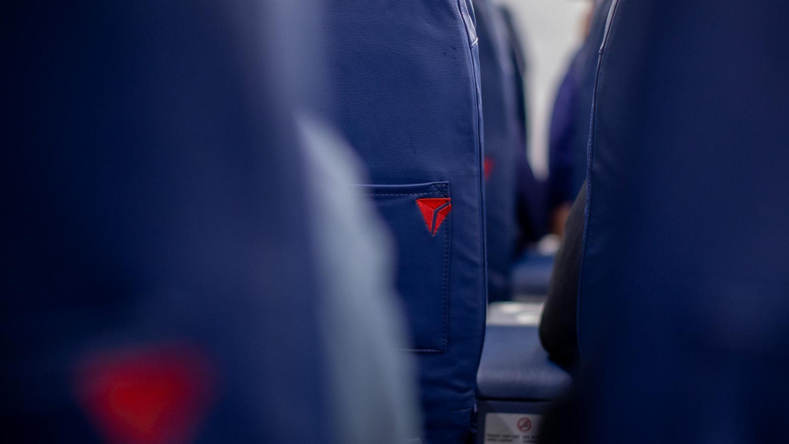 PHOTO: The Delta logo on a seat on a Bombardier CRJ-900 plane during a flight departing from John F. Kennedy International Airport (JFK) in New York, Dec. 19, 2023.