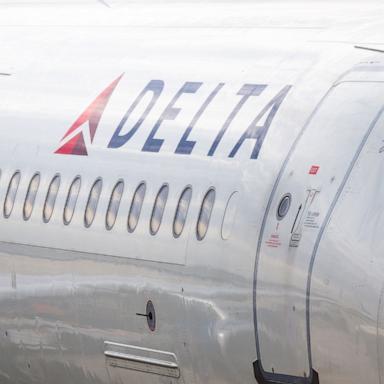 PHOTO: A Delta Airlines plane is stationed at a gate at the Austin-Bergstrom International Airport on January 12, 2026 in Austin, Texas.