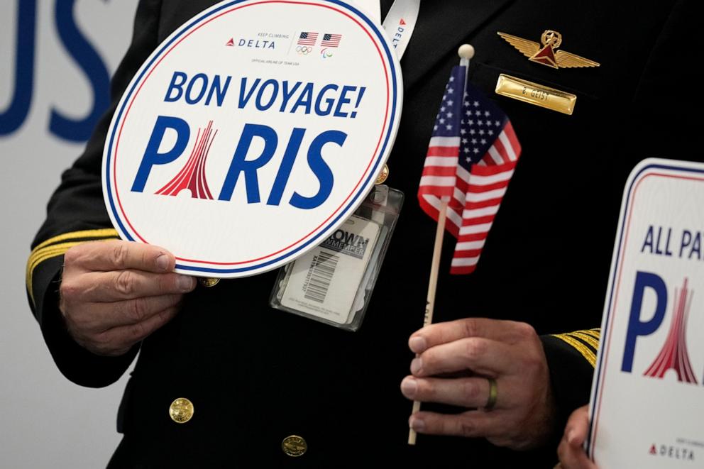 PHOTO: A pilot holds a bon voyage sign as some athletes from the U.S. depart from Hartsfield–Jackson Atlanta International Airport, July 17, 2024, in Atlanta. 