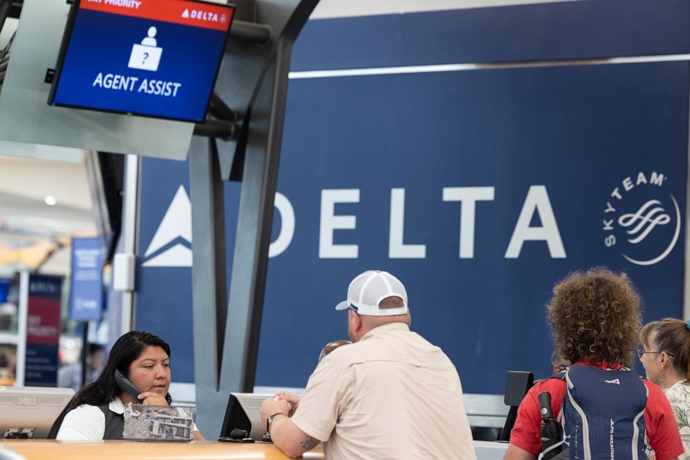 PHOTO: A Delta agent helps passengers after cancelled and delayed flights at Hartsfield-Jackson Atlanta International Airport on July 22, 2024 in Atlanta, Georgia.