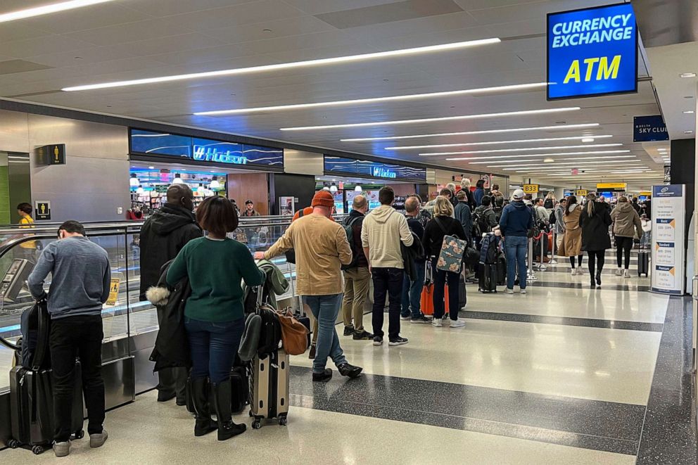 PHOTO: In this Dec. 11, 2022, file photo, travelers wait outside of the Delta Sky Club in Terminal 4 at JFK Airport in New York.