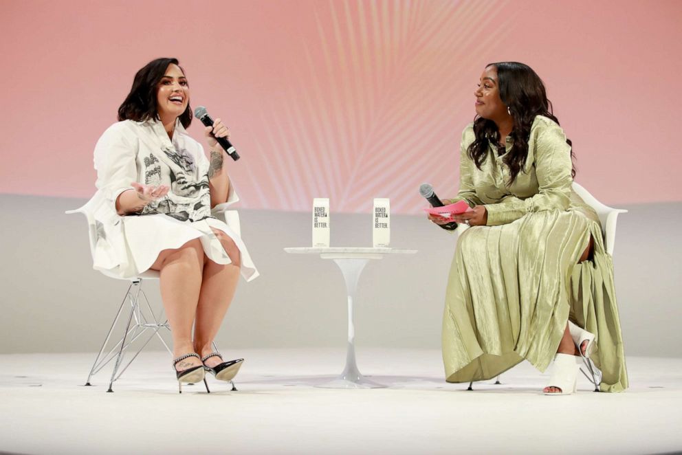 PHOTO: Demi Lovato and Teen Vogue Editor-in-Chief Lindsay Peoples Wagner speak on stage at the Teen Vogue Summit 2019, Nov. 2, 2019, in Los Angeles.
