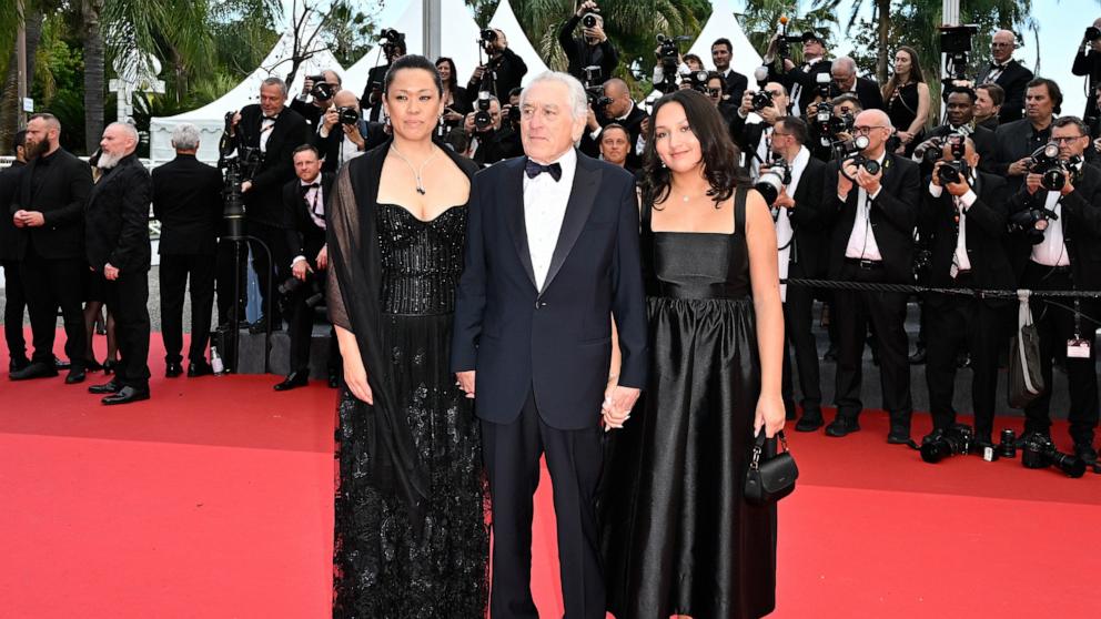 PHOTO: Tiffany Chen, Robert De Niro and Helen Grace De Niro attend the red carpet for the opening ceremony and "Partir Un Jour" (Leave One Day) screening at the 78th annual Cannes Film Festival, May 13, 2025, in Cannes, France. 