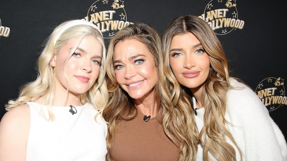 PHOTO: Lola Sheen, Denise Richards and Sami Sheen pose as they promote their new show "Denise Richards and Her Wild Things" at Planet Hollywood Times Square, on Feb. 26, 2025, in New York.