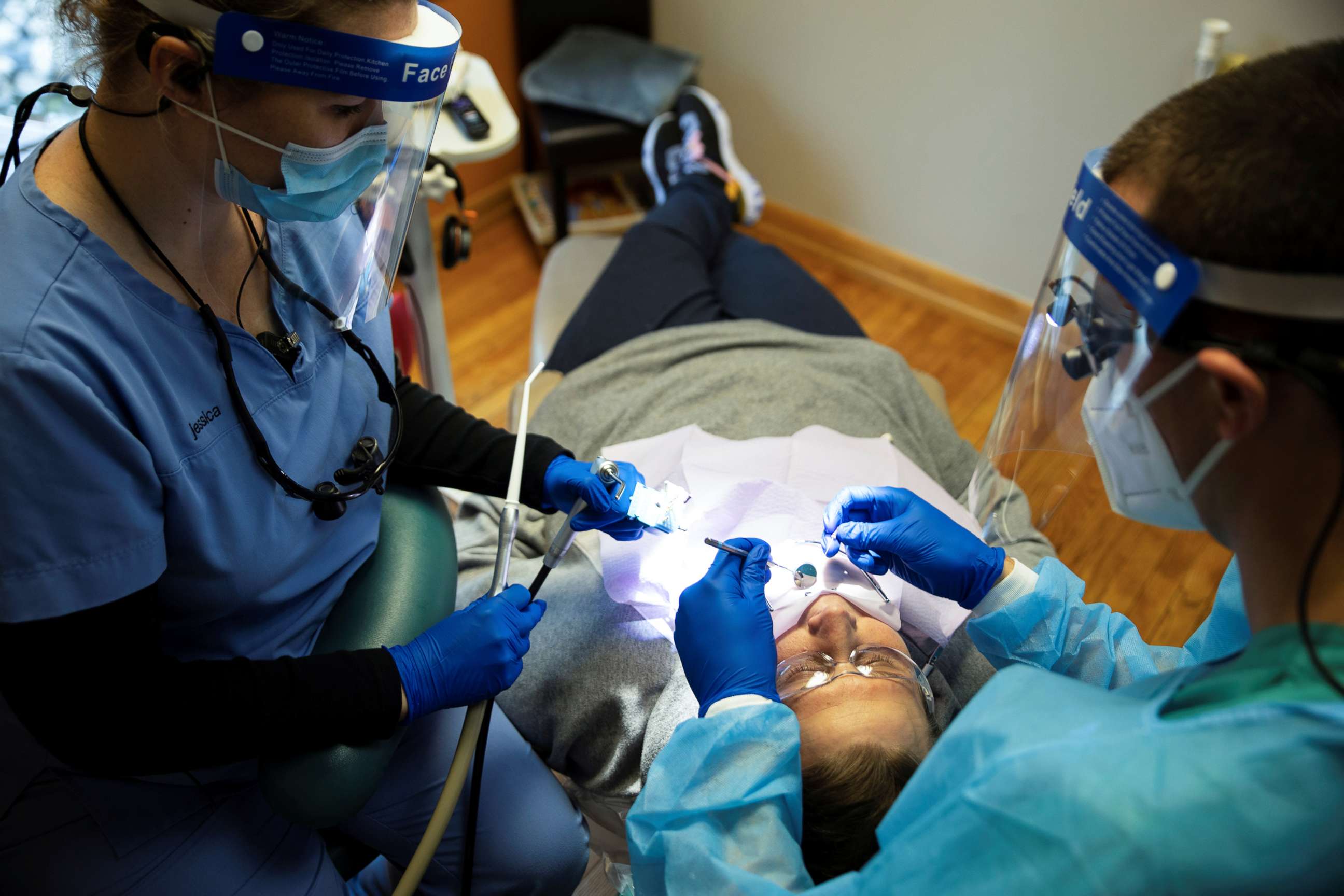 PHOTO: Dentists preform an oral procedure as Ohio implements phase one of reopening dentists, following the outbreak of the coronavirus disease (COVID-19), in Columbus, May 1, 2020. 