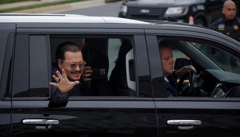 PHOTO: Actor Johnny Depp waves to fans as he arrives at the Fairfax County Circuit Courthouse for his defamation trial against his ex-wife Amber Heard, in Fairfax, Va., May 27, 2022.