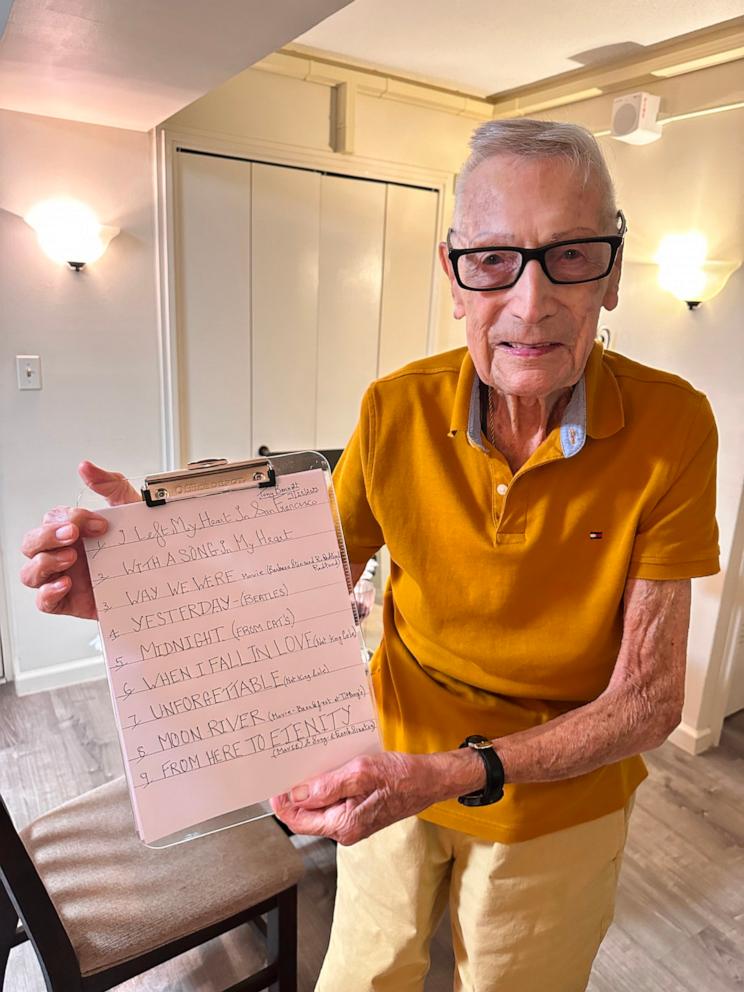 PHOTO: Derek Peart, 97, poses with his song list for "dinner and a show."