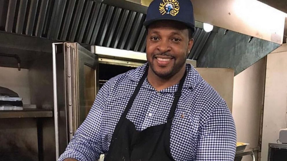 PHOTO: Chef Derrick "Teach" Turton serving a tray of his famous macaroni and cheese.