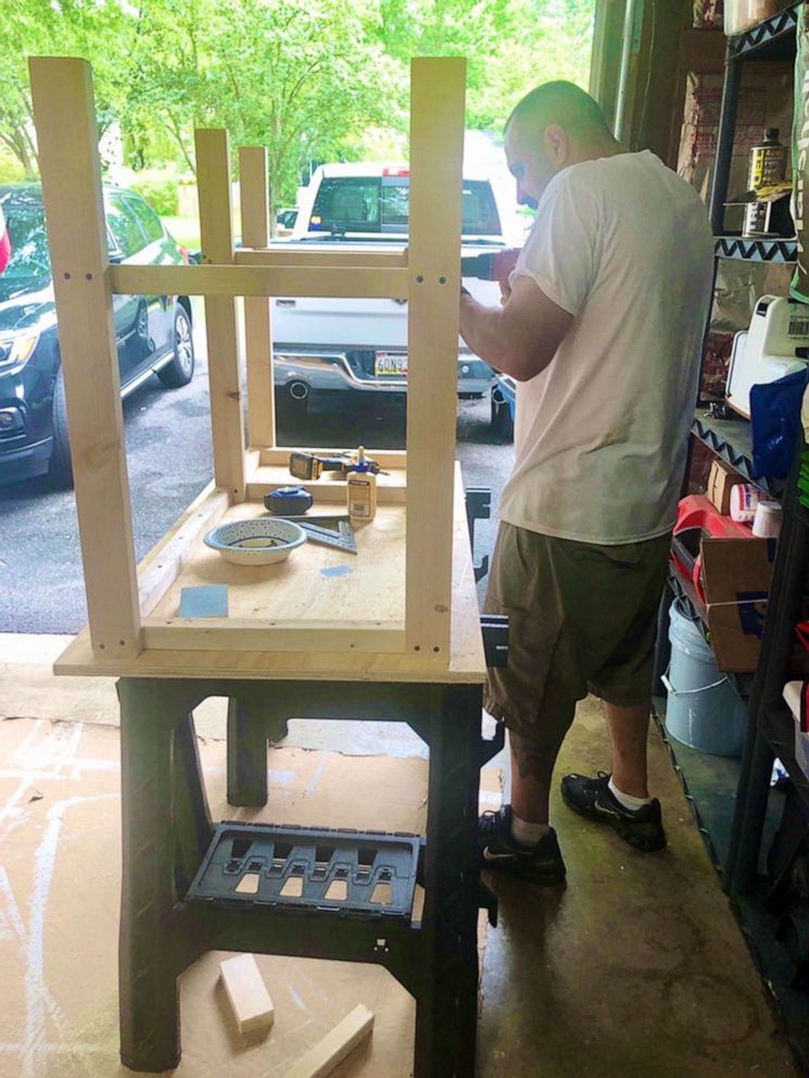 PHOTO: A member of Desks by Dads works on one of than 30 desks the group has distributed for students studying at home during the coronavirus pandemic.