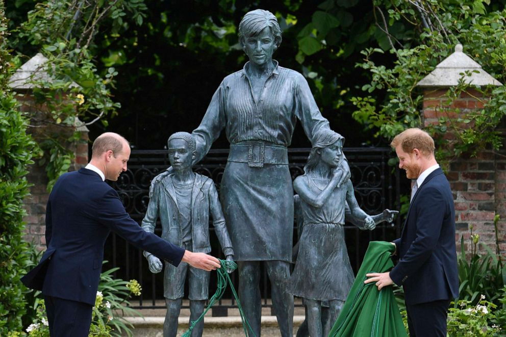PHOTO: Britain's Prince William, left and Prince Harry unveil a statue they commissioned of their mother Princess Diana,  on what would have been her 60th birthday, in the Sunken Garden at Kensington Palace, London, July 1, 2021. 