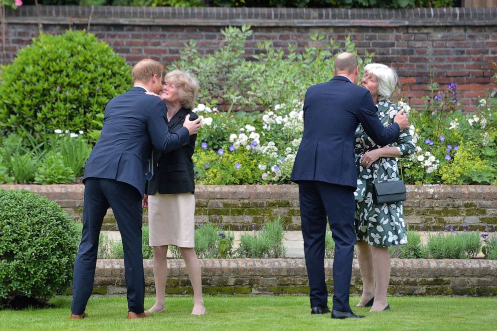 PHOTO: Britain's Prince William, second right and Prince Harry, left greet their aunts as they unveil a statue they commissioned of their mother Princess Diana in the Sunken Garden at Kensington Palace, London, July 1, 2021.