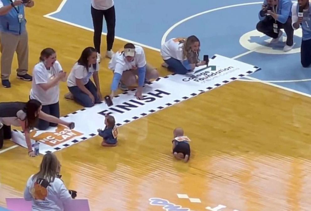 PHOTO: Babies compete in the "Diapers to Dorms Dash" at the March 4, 2023, basketball game between Duke University and the University of North Carolina in Chapel Hill.