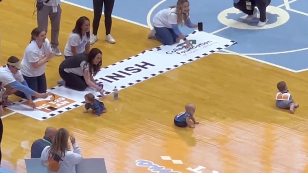 PHOTO: Babies compete in the "Diapers to Dorms Dash" at the March 4, 2023, basketball game between Duke University and the University of North Carolina in Chapel Hill.