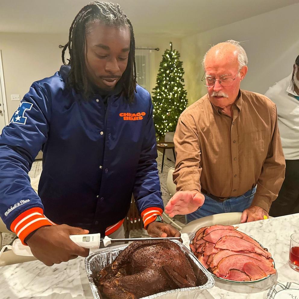 PHOTO: Jaylen Lockhart carves a turkey at Thanksgiving with Guy Miller's family.