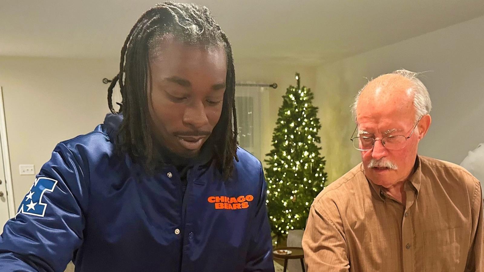 PHOTO: Jaylen Lockhart carves a turkey at Thanksgiving with Guy Miller's family.