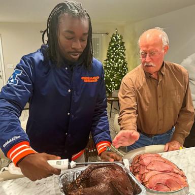 PHOTO: Jaylen Lockhart carves a turkey at Thanksgiving with Guy Miller's family.