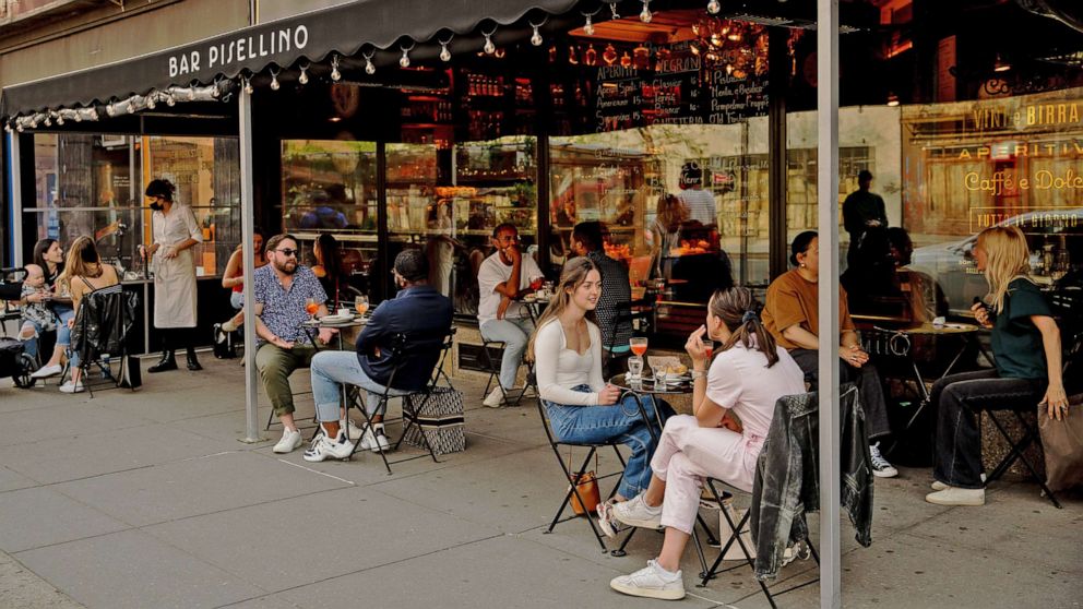 PHOTO: Customers sit in the outdoor dining area of a restaurant in the West Village neighborhood of New York, April 28, 2021.