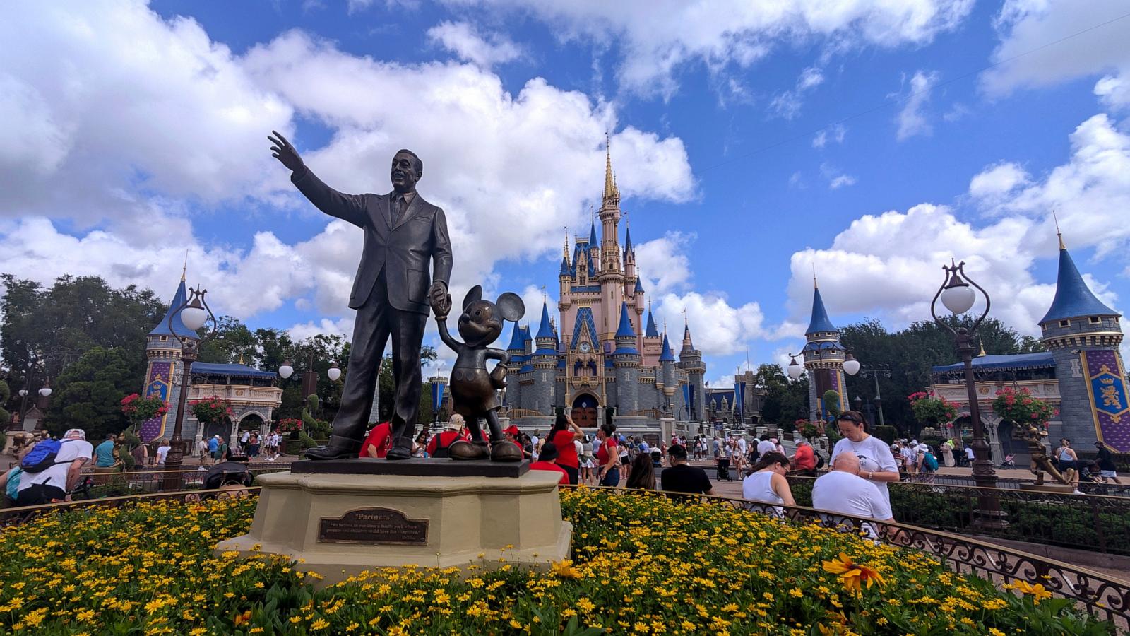 PHOTO: A statue of Walt Disney and Mickey Mouse stands in a garden in front of Cinderella's Castle at the Magic Kingdom Park at Walt Disney World, April 3, 2025, in Orlando, Fla.
