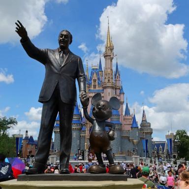 PHOTO: A statue of Walt Disney and Mickey Mouse stands in a garden in front of Cinderella's Castle at the Magic Kingdom Park at Walt Disney World, April 3, 2025, in Orlando, Fla.