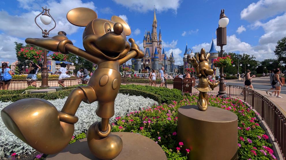 PHOTO: Statues of Mickey Mouse and Minnie Mouse stand in a garden in front of Cinderella's Castle at the Magic Kingdom Park at Walt Disney World on April 3, 2025, in Orlando, Florida.